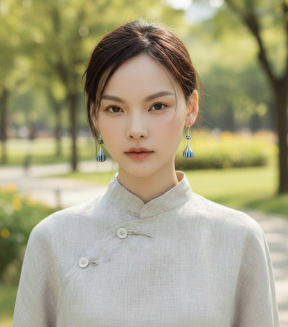 Deep blue enamel droplet earrings reflecting calm ocean tones — handmade enamel silver earrings ideal for poetic and elegant styles.
