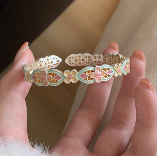 Handcrafted enamel cuff bracelet with hand-colored petals and vintage Chinese bangle design
