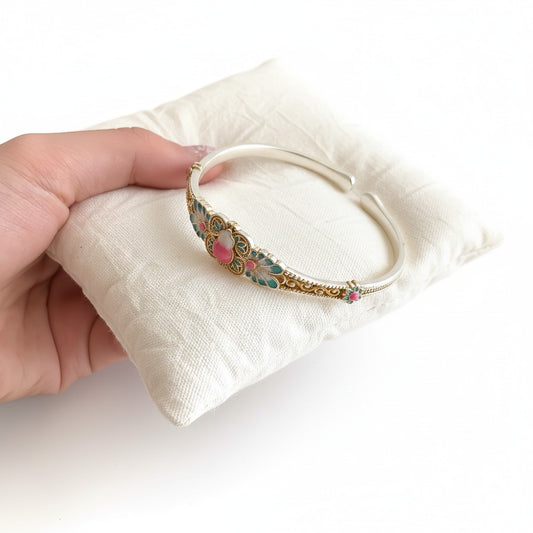 Handmade bracelet blending filigree and enamel that blooms with intricate floral patterns — a wearable garden of eastern elegance.
