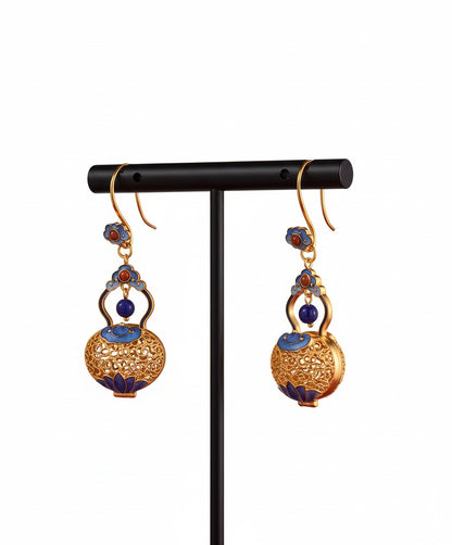Handcrafted filigree silver earrings featuring gourd motif — meticulous detail that carries blessings of luck and prosperity.

