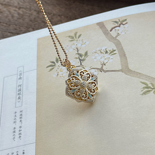 Pendant combining delicate hollow silverwork with smooth enamel — a balanced piece of Chinese enamel jewelry suitable for layering or gifting.
