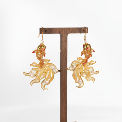 Handmade silver stud earrings depicting koi fish in intricate filigree — symbolizing luck, courage, and prosperity.