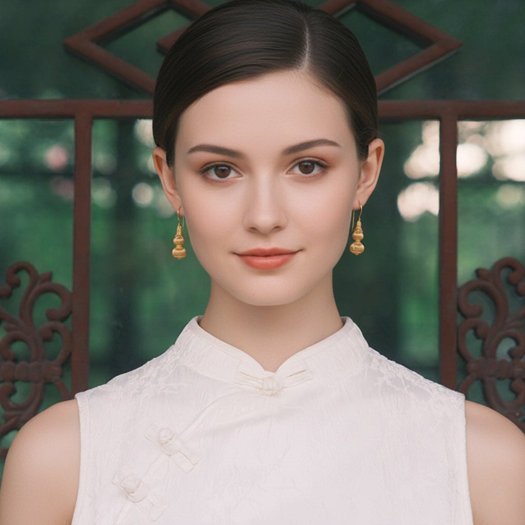 Gold-plated sterling silver gourd stud earrings with filigree-style texture
